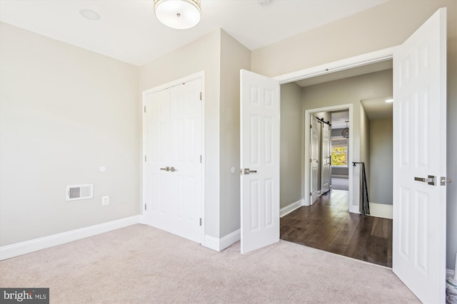 unfurnished bedroom featuring carpet floors and a closet