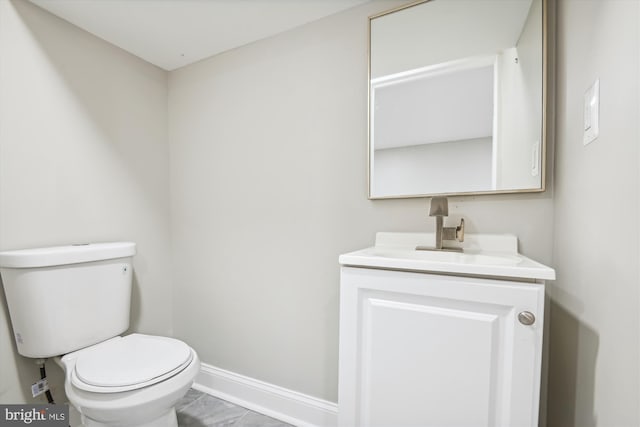 bathroom with vanity, toilet, and tile patterned floors