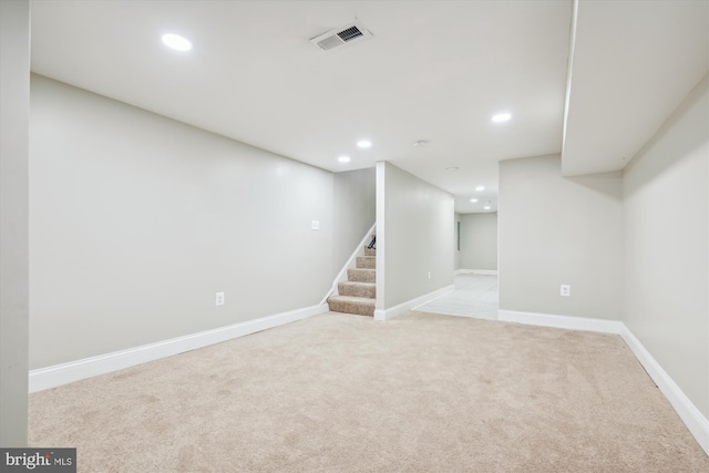 basement featuring light carpet