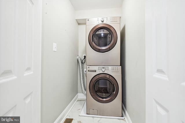 laundry room with stacked washing maching and dryer