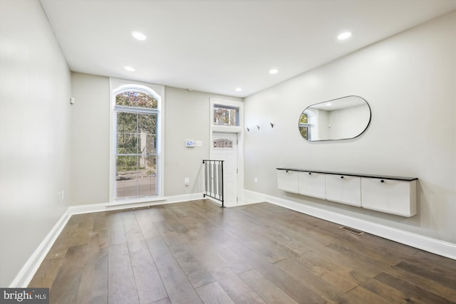 unfurnished living room with wood-type flooring