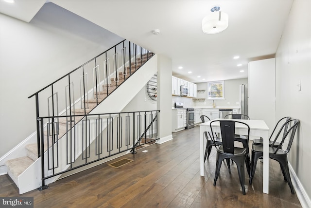 dining space featuring dark hardwood / wood-style flooring