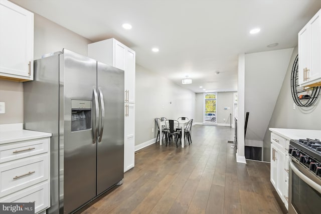 kitchen featuring dark wood-type flooring, appliances with stainless steel finishes, and white cabinets