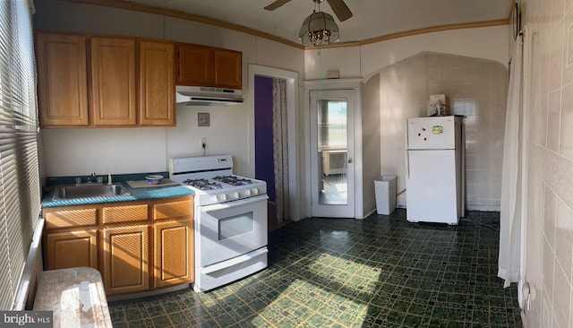 kitchen with ceiling fan, tile walls, crown molding, sink, and white appliances