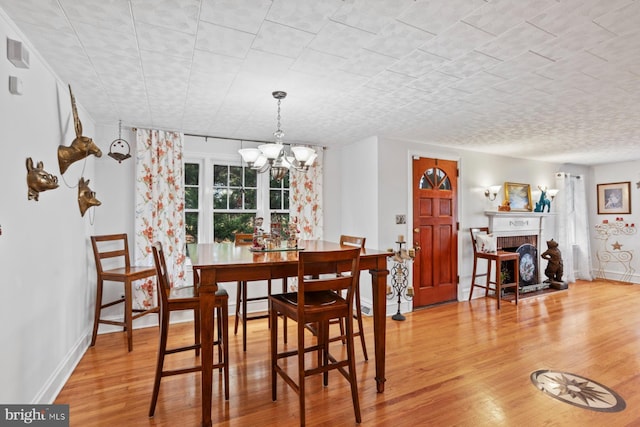 dining space featuring an inviting chandelier and light hardwood / wood-style floors