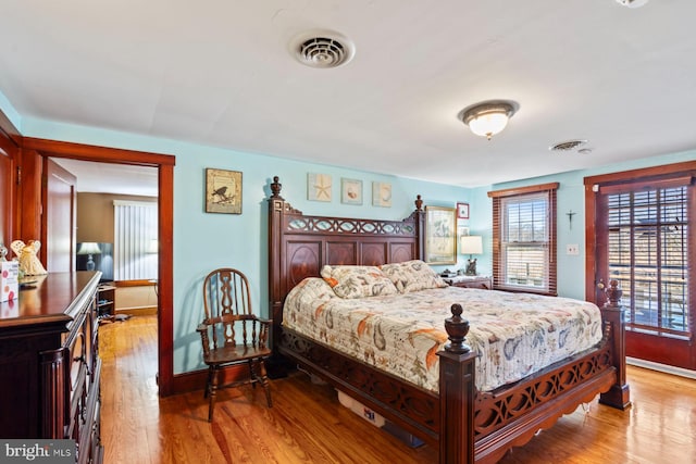 bedroom featuring access to outside and light hardwood / wood-style flooring