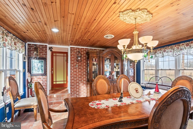 tiled dining space with brick wall, a notable chandelier, and wood ceiling