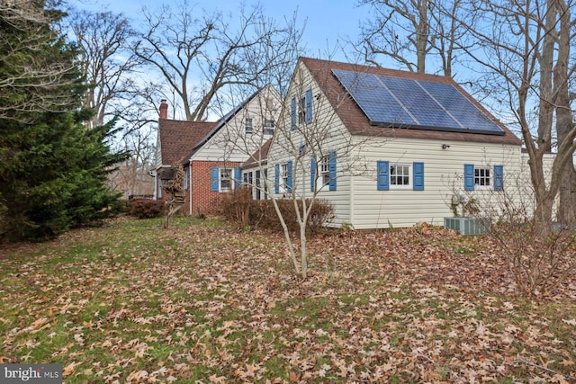 view of side of home with solar panels