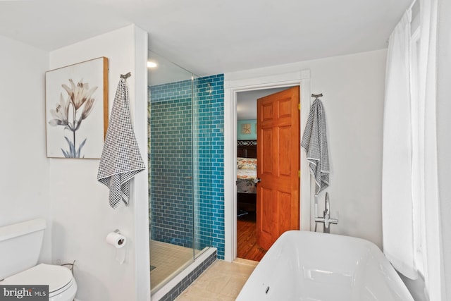 bathroom featuring tile patterned floors, shower with separate bathtub, and toilet