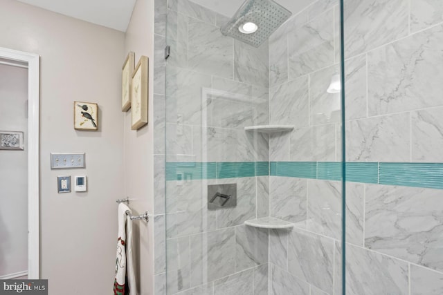 bathroom with a tile shower