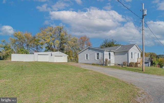 view of side of home with an outbuilding and a lawn