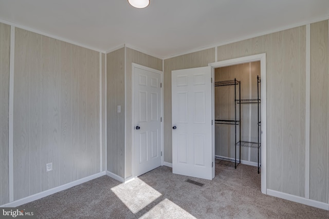 unfurnished bedroom with baseboards, visible vents, and carpet flooring