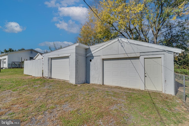 garage featuring a lawn