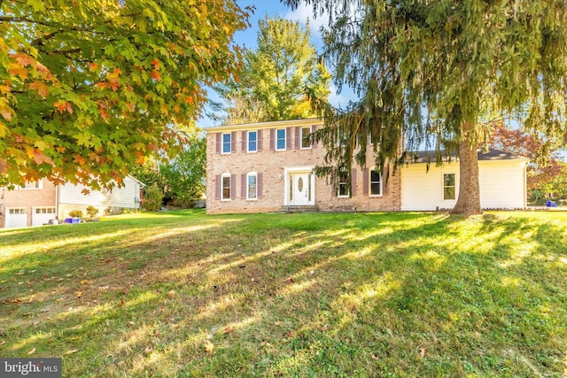 colonial-style house with a front lawn