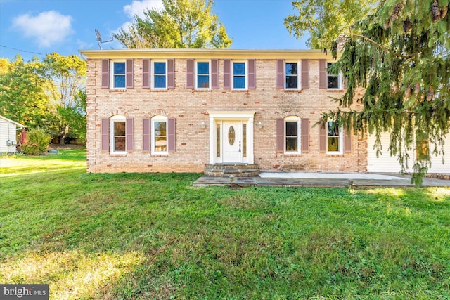 view of front of property with a patio area and a front lawn