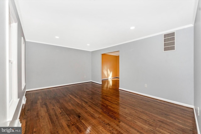 unfurnished room featuring crown molding and dark wood-type flooring