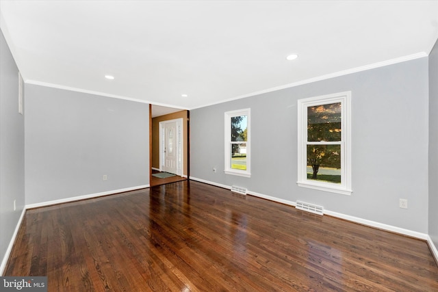 empty room with ornamental molding and wood-type flooring