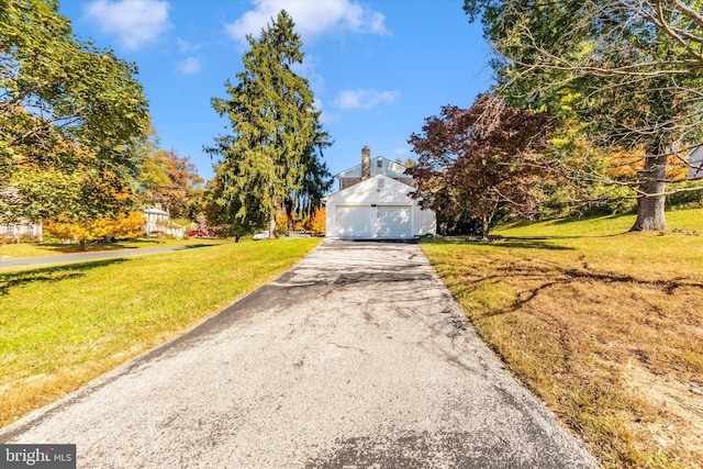 view of front of property featuring a front lawn and a garage