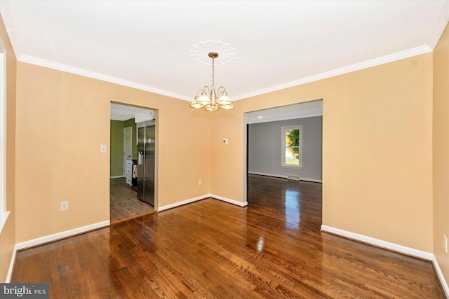 unfurnished room featuring ornamental molding, hardwood / wood-style floors, and an inviting chandelier