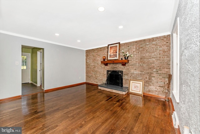 unfurnished living room featuring ornamental molding and hardwood / wood-style floors