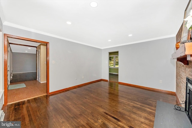 unfurnished living room featuring ornamental molding, a brick fireplace, and dark hardwood / wood-style flooring