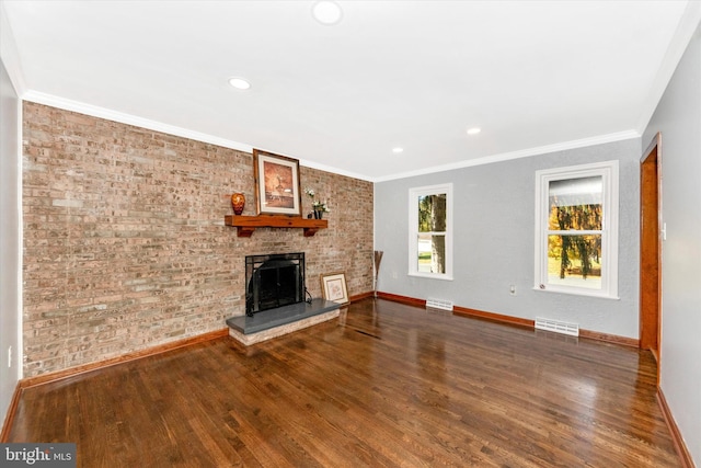 unfurnished living room featuring ornamental molding, a brick fireplace, and hardwood / wood-style flooring