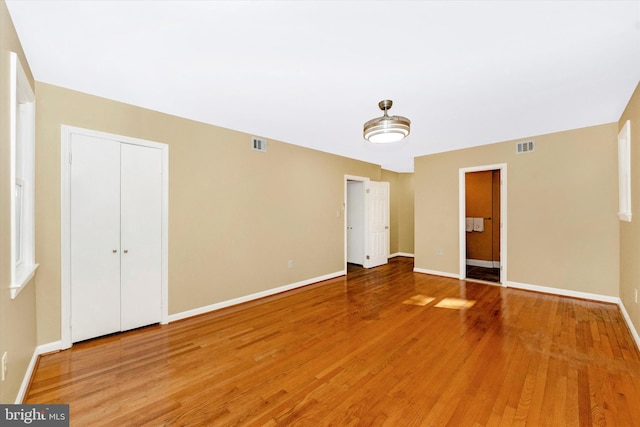 empty room with hardwood / wood-style floors