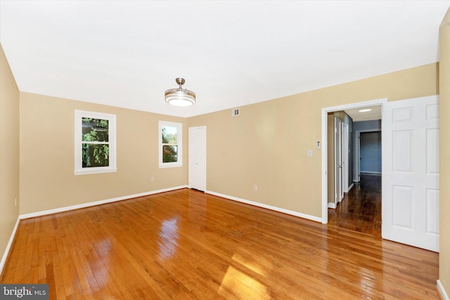 empty room with hardwood / wood-style flooring