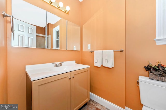 bathroom with toilet, a shower with shower door, vanity, and tile patterned floors