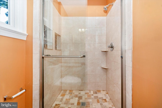 bathroom with a shower with shower door