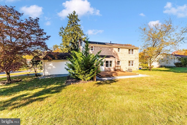 back of property featuring a patio area and a lawn