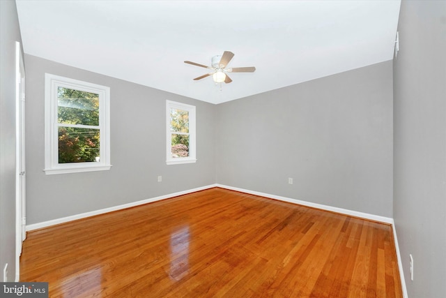 empty room with wood-type flooring and ceiling fan