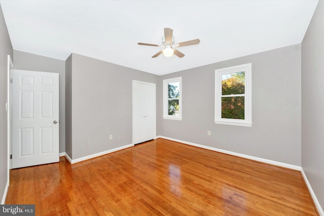 spare room featuring hardwood / wood-style floors and ceiling fan