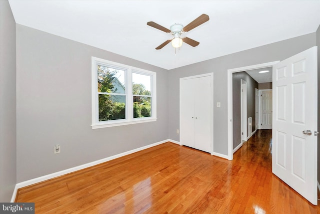 unfurnished bedroom featuring ceiling fan and hardwood / wood-style flooring