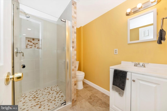 bathroom featuring vanity, an enclosed shower, and toilet