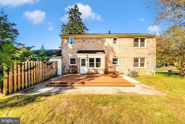 rear view of property with a yard, central AC, and a wooden deck