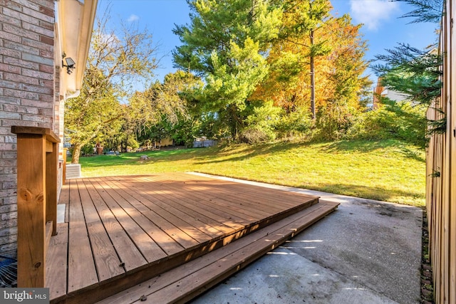 wooden deck featuring a yard