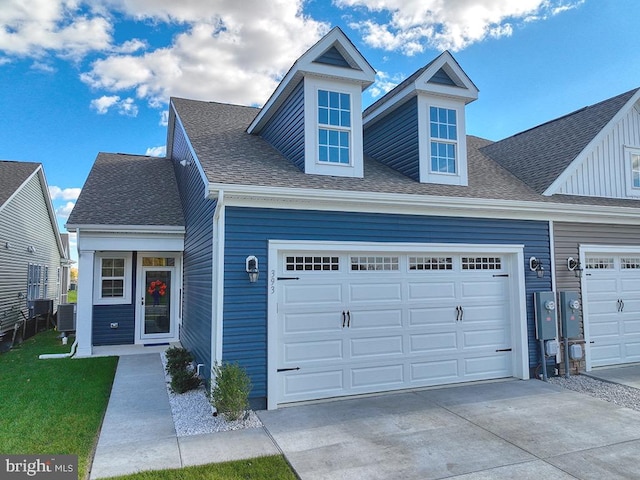 view of front of house with central AC unit and a garage