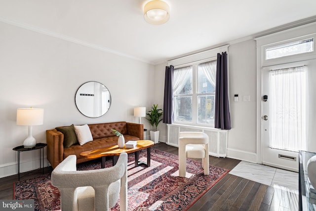 living room featuring dark hardwood / wood-style flooring and crown molding