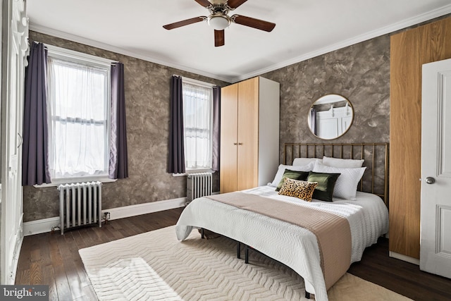 bedroom with ceiling fan, radiator heating unit, crown molding, and dark hardwood / wood-style floors