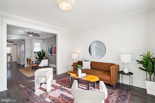 living room with dark wood-type flooring, ceiling fan, and crown molding