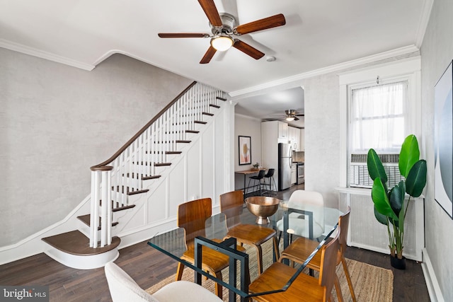 dining room with dark hardwood / wood-style floors, ceiling fan, and crown molding