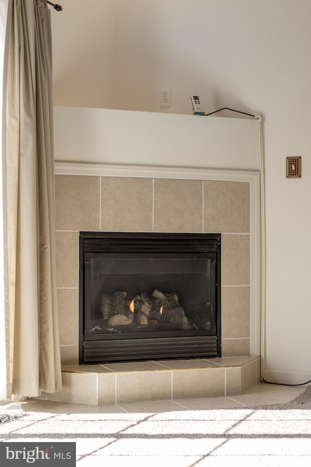 room details featuring a tile fireplace