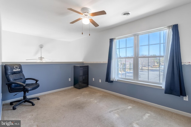 carpeted office featuring visible vents and baseboards