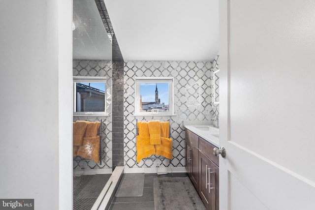 bathroom with vanity and tile walls