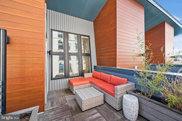 wooden terrace featuring an outdoor hangout area