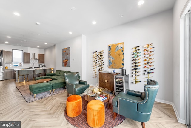 living room featuring light parquet floors and sink