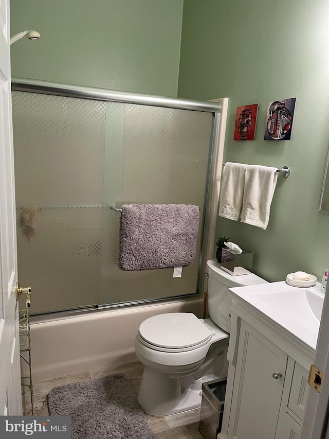 full bathroom with toilet, vanity, and shower / bath combination with glass door