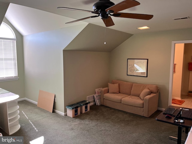 carpeted living room featuring vaulted ceiling and ceiling fan