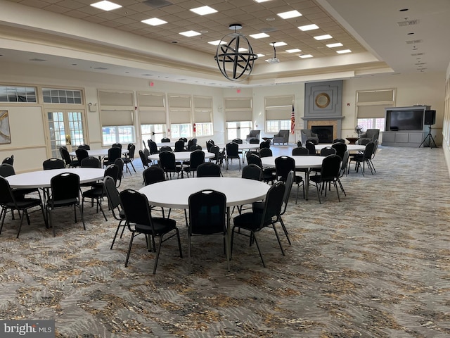 dining space with a high ceiling and a tray ceiling